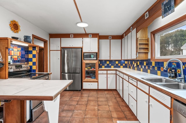 4 Sauer Ter, Durham, NH 03824 - kitchen with stainless steel appliances, tile counters, decorative backsplash, and white cabinetry