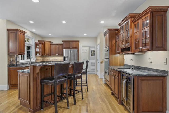 4 Chablis Ct, Bedford, NH 03110 - kitchen with wine cooler, stainless steel appliances, open shelves, light wood-type flooring, and recessed lighting