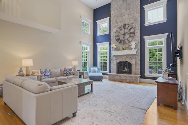 4 Chablis Ct, Bedford, NH 03110 - living room with wood finished floors, a towering ceiling, and a stone fireplace