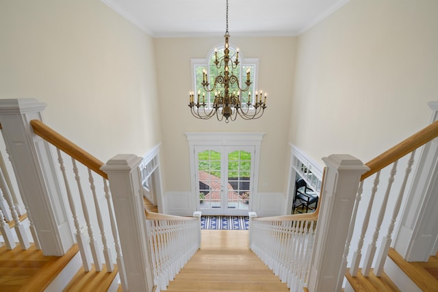 4 Chablis Ct, Bedford, NH 03110 - stairs featuring french doors, a chandelier, wood finished floors, a wainscoted wall, and a towering ceiling