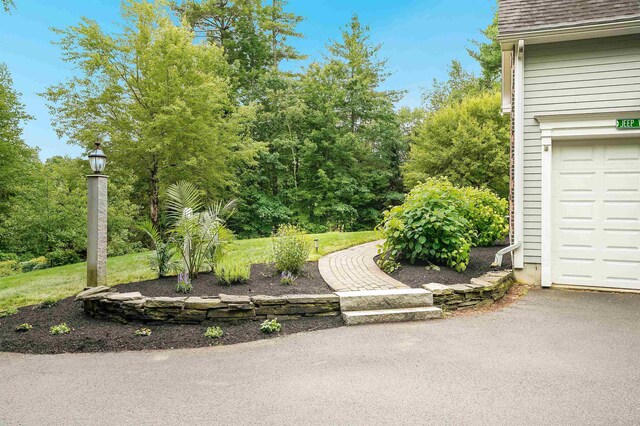 4 Chablis Ct, Bedford, NH 03110 - view of yard with a garage and driveway