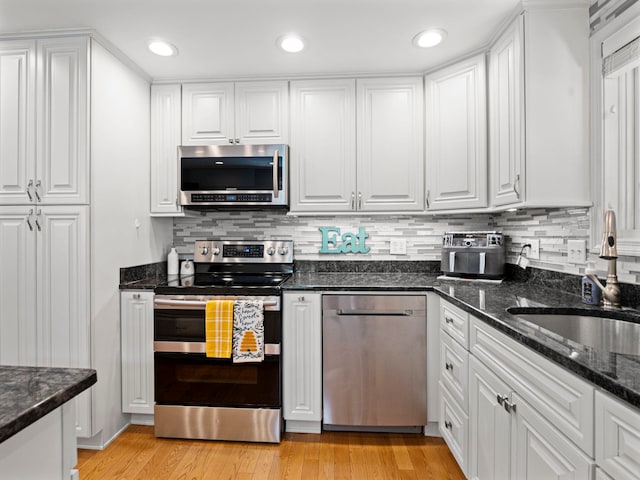 44 Mcquade Brook Rd, Bedford, NH 03110 - kitchen featuring stainless steel appliances, white cabinetry, backsplash, light wood-type flooring, and recessed lighting