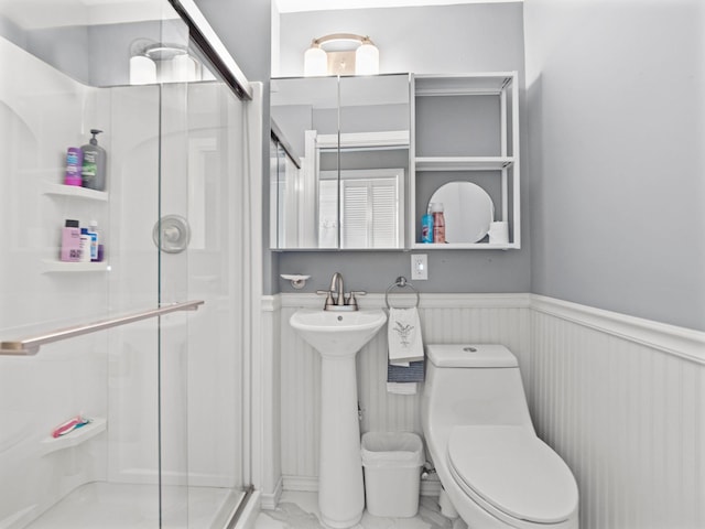 44 Mcquade Brook Rd, Bedford, NH 03110 - bathroom with a wainscoted wall, a shower stall, and marble look tile flooring
