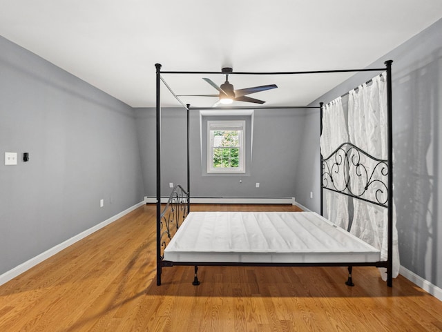 44 Mcquade Brook Rd, Bedford, NH 03110 - bedroom featuring wood finished floors and a baseboard heating unit