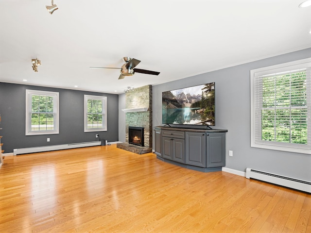 44 Mcquade Brook Rd, Bedford, NH 03110 - unfurnished living room featuring a baseboard heating unit, a ceiling fan, a stone fireplace, light wood-style flooring, and recessed lighting