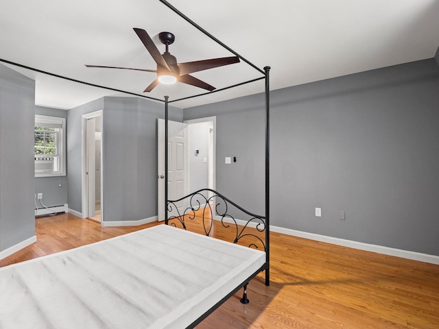 44 Mcquade Brook Rd, Bedford, NH 03110 - bedroom featuring a baseboard radiator, light wood finished floors, ceiling fan, and cooling unit