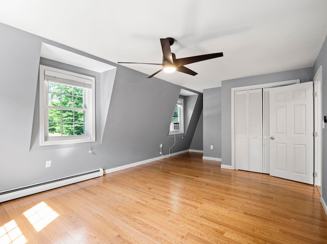 44 Mcquade Brook Rd, Bedford, NH 03110 - unfurnished bedroom featuring multiple windows, light wood-style flooring, a closet, and a ceiling fan