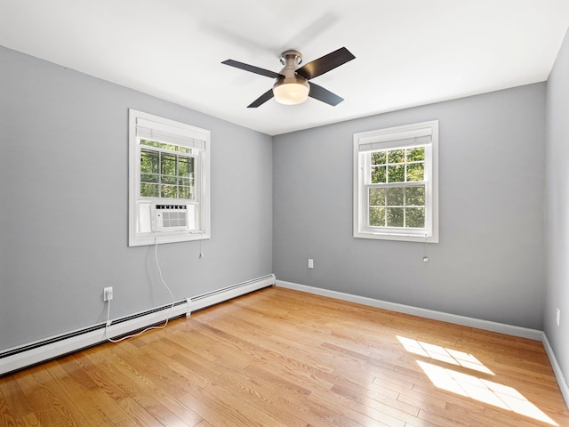 44 Mcquade Brook Rd, Bedford, NH 03110 - empty room featuring plenty of natural light, cooling unit, a baseboard radiator, and light wood-style floors