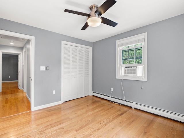 44 Mcquade Brook Rd, Bedford, NH 03110 - unfurnished bedroom with a baseboard heating unit, cooling unit, attic access, light wood-type flooring, and a closet