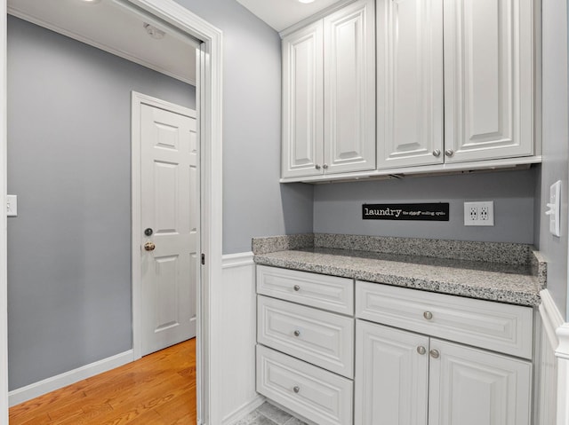 44 Mcquade Brook Rd, Bedford, NH 03110 - kitchen with white cabinetry, light wood-type flooring, and light stone countertops