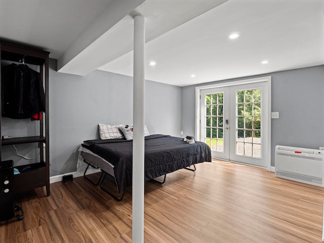 44 Mcquade Brook Rd, Bedford, NH 03110 - bedroom with french doors, access to exterior, wood finished floors, heating unit, and recessed lighting