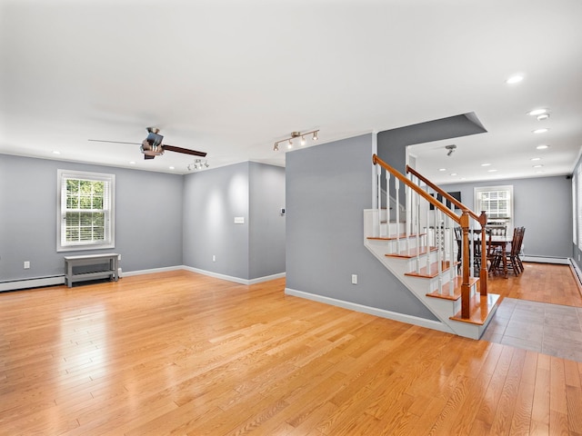 44 Mcquade Brook Rd, Bedford, NH 03110 - unfurnished living room featuring a ceiling fan, stairs, light wood-type flooring, and recessed lighting