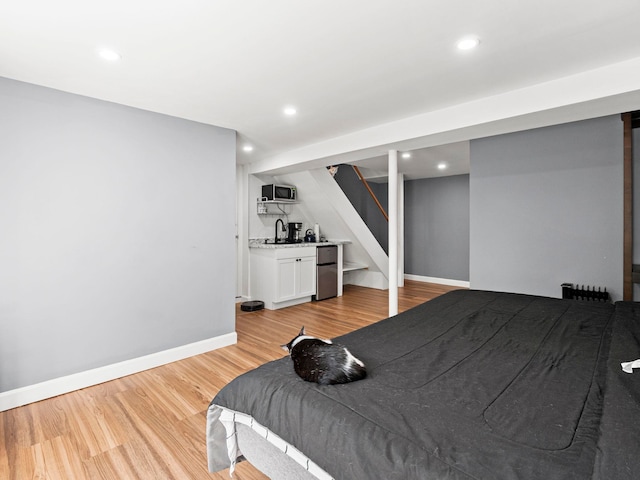44 Mcquade Brook Rd, Bedford, NH 03110 - bedroom with freestanding refrigerator, light wood-style floors, and recessed lighting