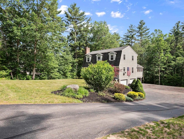 44 Mcquade Brook Rd, Bedford, NH 03110 - view of front facade featuring driveway, a chimney, an attached garage, a gambrel roof, and a front lawn