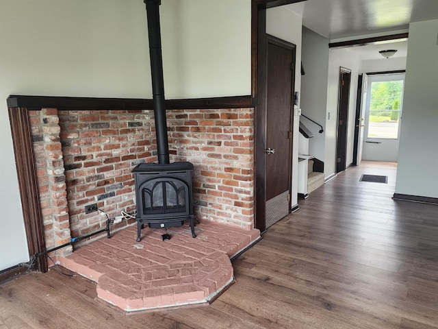 33 Pendleton Ln, Londonderry, NH 03053 - detailed view of wood finished floors and a wood stove