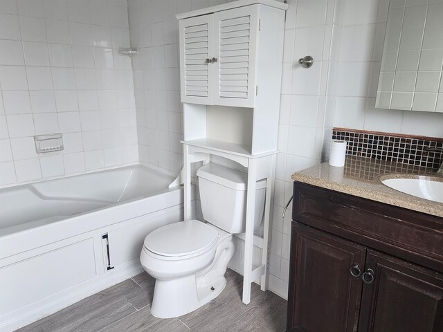 33 Pendleton Ln, Londonderry, NH 03053 - full bath with vanity, tub / shower combination, wood finished floors, and backsplash
