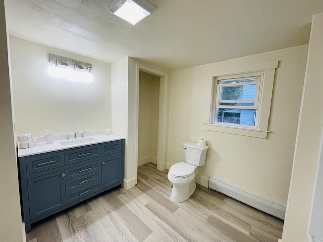 17 Arch St, Laconia, NH 03246 - bathroom featuring a baseboard radiator, wood finished floors, and vanity