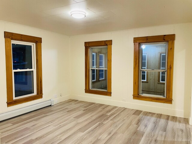 17 Arch St, Laconia, NH 03246 - spare room featuring light wood-style floors and a baseboard heating unit