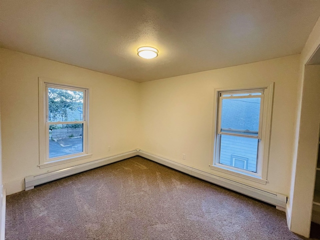 17 Arch St, Laconia, NH 03246 - spare room featuring dark colored carpet, a baseboard heating unit, and baseboard heating