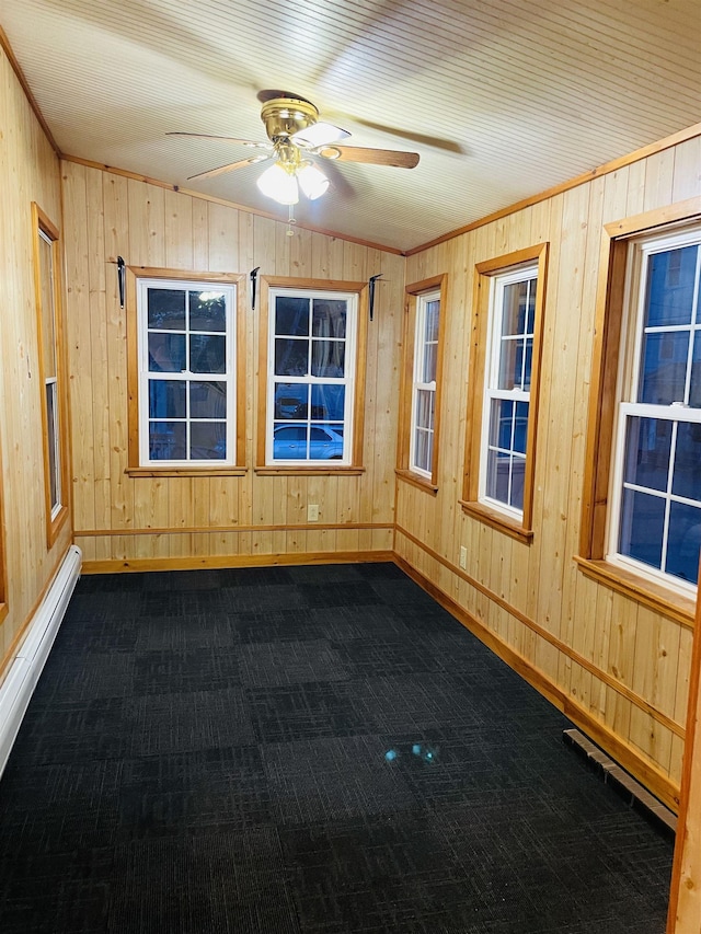 17 Arch St, Laconia, NH 03246 - unfurnished room with baseboard heating, wooden walls, a ceiling fan, and dark colored carpet