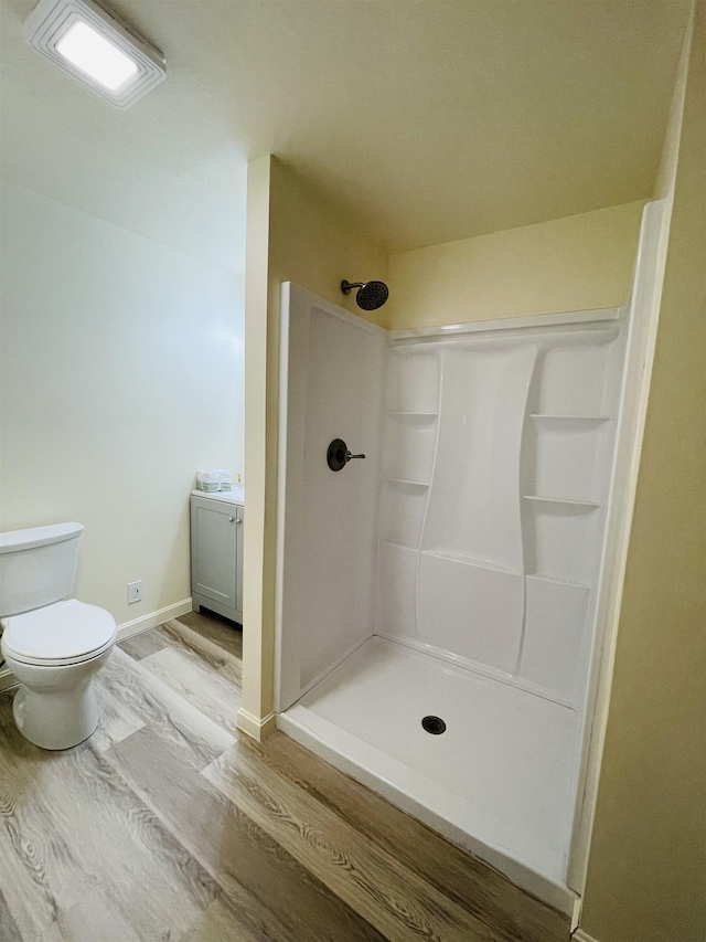 17 Arch St, Laconia, NH 03246 - bathroom featuring a shower stall, wood finished floors, and vanity