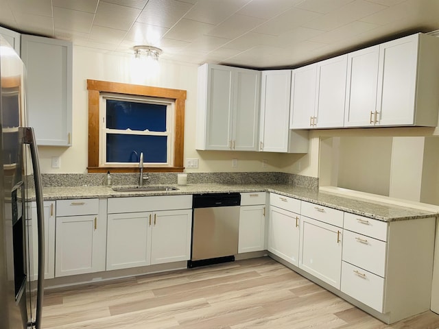 17 Arch St, Laconia, NH 03246 - kitchen with stainless steel dishwasher, light stone countertops, black fridge with ice dispenser, and white cabinets