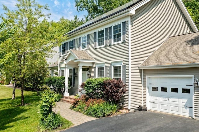 473 Brennan Woods Dr, Williston, VT 05495 - colonial inspired home featuring a garage, roof with shingles, asphalt driveway, and a front yard