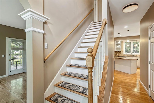 473 Brennan Woods Dr, Williston, VT 05495 - staircase featuring hardwood / wood-style floors, decorative columns, and recessed lighting