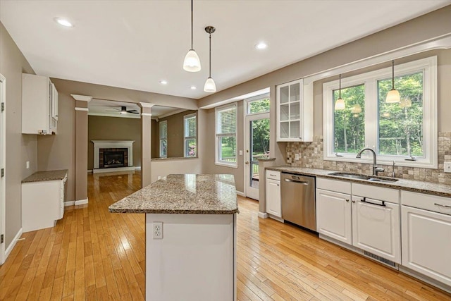 473 Brennan Woods Dr, Williston, VT 05495 - kitchen with stainless steel dishwasher, a center island, ceiling fan, white cabinetry, and light wood finished floors