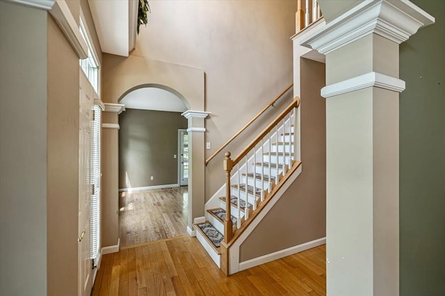 473 Brennan Woods Dr, Williston, VT 05495 - foyer with ornate columns, arched walkways, wood finished floors, a high ceiling, and stairway