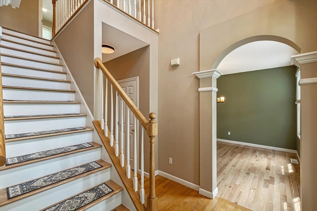 473 Brennan Woods Dr, Williston, VT 05495 - staircase with arched walkways, wood finished floors, and ornate columns