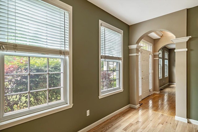 473 Brennan Woods Dr, Williston, VT 05495 - entryway with ornate columns, arched walkways, and light wood-style floors