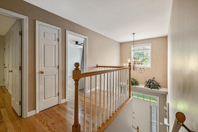 473 Brennan Woods Dr, Williston, VT 05495 - corridor with an upstairs landing, light wood-style floors, and a chandelier
