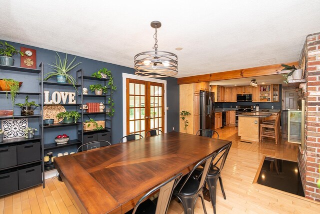 33 Hillside Rd, Kingston, NH 03848 - dining space with light wood-style floors, a textured ceiling, and french doors