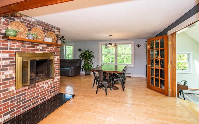 33 Hillside Rd, Kingston, NH 03848 - dining space with plenty of natural light, wood finished floors, a fireplace, and a baseboard radiator