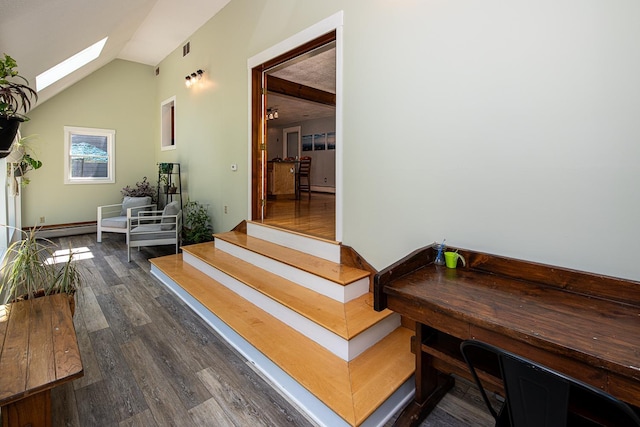 33 Hillside Rd, Kingston, NH 03848 - corridor featuring vaulted ceiling, dark wood-type flooring, a skylight, a baseboard heating unit, and stairway