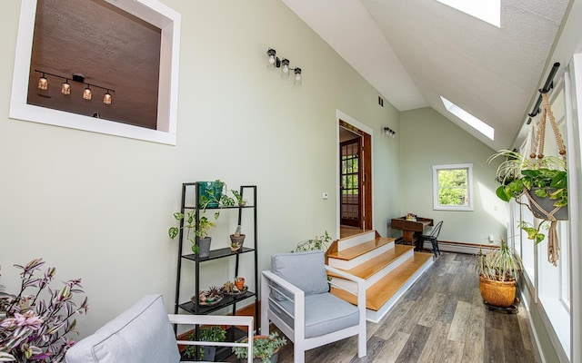 33 Hillside Rd, Kingston, NH 03848 - hallway featuring a skylight, wood finished floors, a textured ceiling, lofted ceiling, and a baseboard heating unit