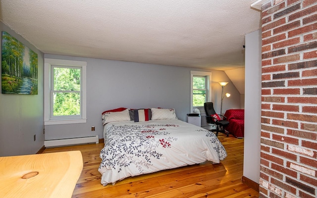 33 Hillside Rd, Kingston, NH 03848 - bedroom featuring a baseboard heating unit, light wood-type flooring, and a textured ceiling