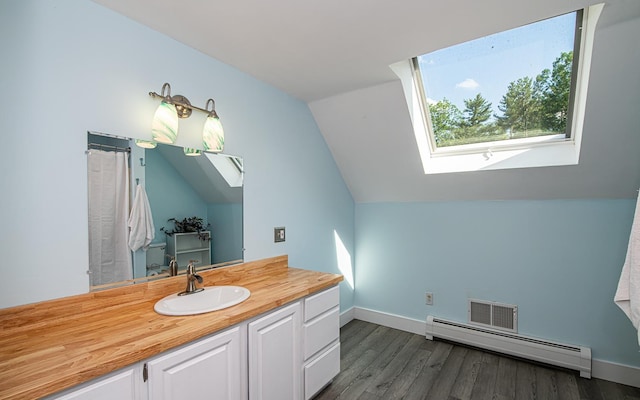 33 Hillside Rd, Kingston, NH 03848 - full bathroom featuring a skylight, a baseboard radiator, lofted ceiling, vanity, and wood finished floors