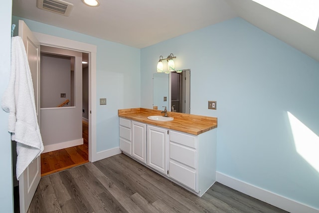33 Hillside Rd, Kingston, NH 03848 - bathroom with vanity, wood finished floors, recessed lighting, and vaulted ceiling