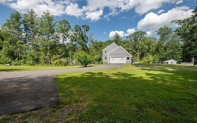 33 Hillside Rd, Kingston, NH 03848 - view of green lawn with asphalt driveway and a garage