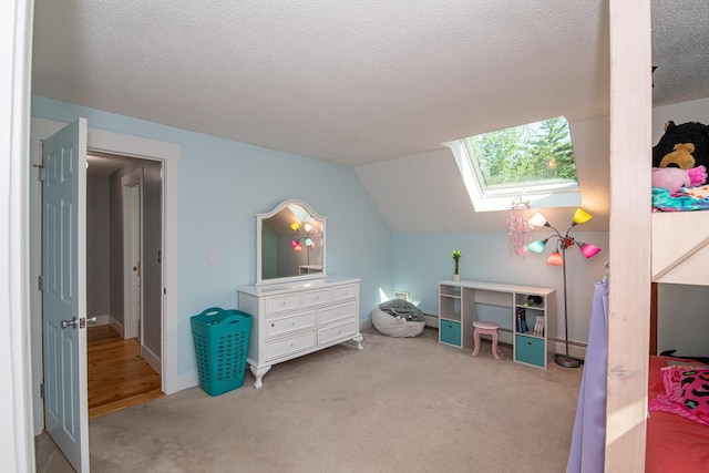 33 Hillside Rd, Kingston, NH 03848 - bedroom featuring a skylight, light colored carpet, vaulted ceiling, a textured ceiling, and a baseboard heating unit