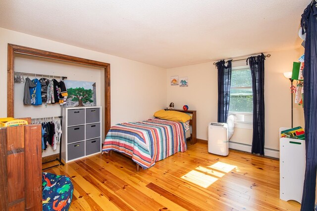 33 Hillside Rd, Kingston, NH 03848 - bedroom with hardwood / wood-style floors and a baseboard heating unit