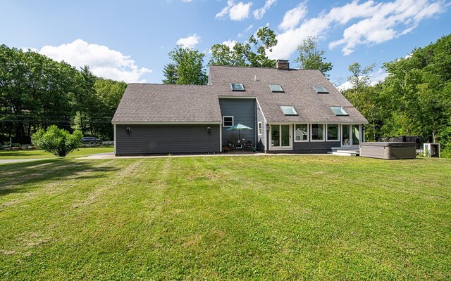 33 Hillside Rd, Kingston, NH 03848 - back of property featuring a hot tub, a shingled roof, a patio, a lawn, and a chimney