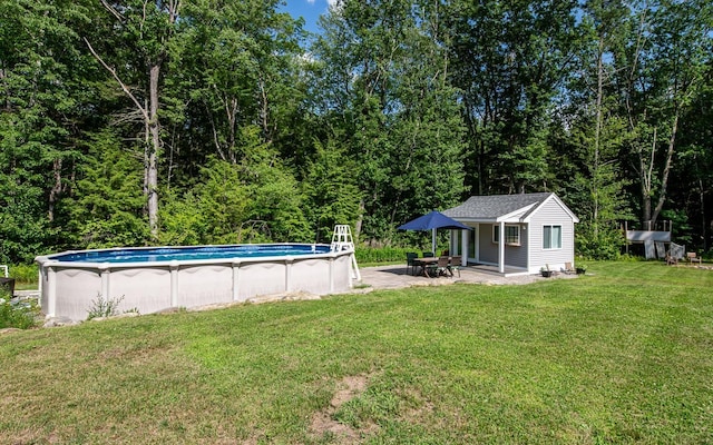 33 Hillside Rd, Kingston, NH 03848 - view of grassy yard featuring an outbuilding, an outdoor pool, and a forest view