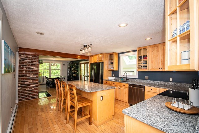 33 Hillside Rd, Kingston, NH 03848 - kitchen featuring black appliances, a baseboard radiator, a center island, a textured ceiling, and light wood-style floors