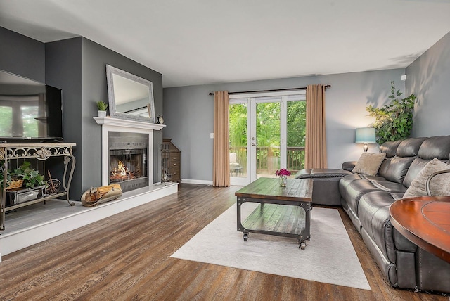 37 Thornhill Rd, Stratham, NH 03885 - living room featuring wood finished floors and a warm lit fireplace