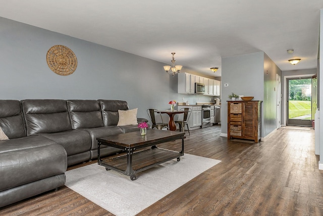 37 Thornhill Rd, Stratham, NH 03885 - living room featuring a chandelier and dark wood-style floors