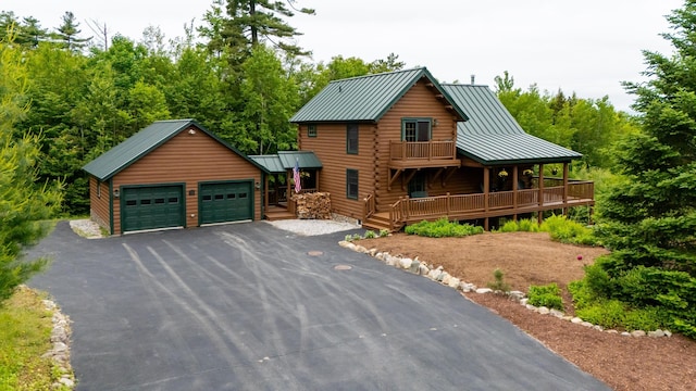 1 Peak Vista Ln, Madison, NH 03849 - log home featuring log siding, a garage, a metal roof, a standing seam roof, and asphalt driveway