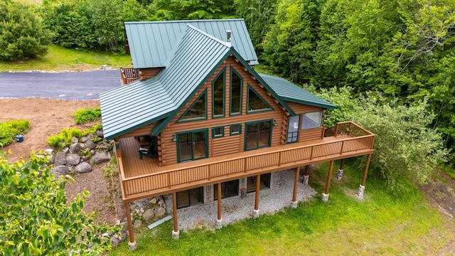 1 Peak Vista Ln, Madison, NH 03849 - rear view of house with a standing seam roof, log exterior, a deck, and stone siding